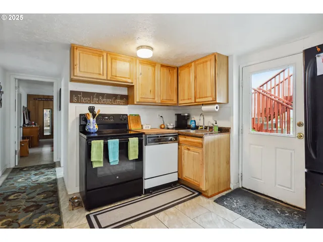 a kitchen with a stove a sink and a microwave