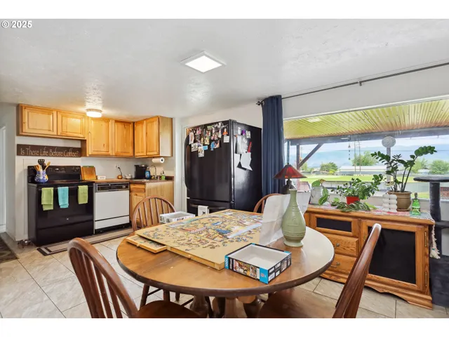 a dining room with furniture a rug and wooden floor