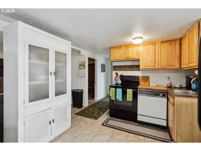 a kitchen with granite countertop a stove and cabinets