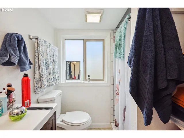 a bathroom with a toilet sink and shower curtain