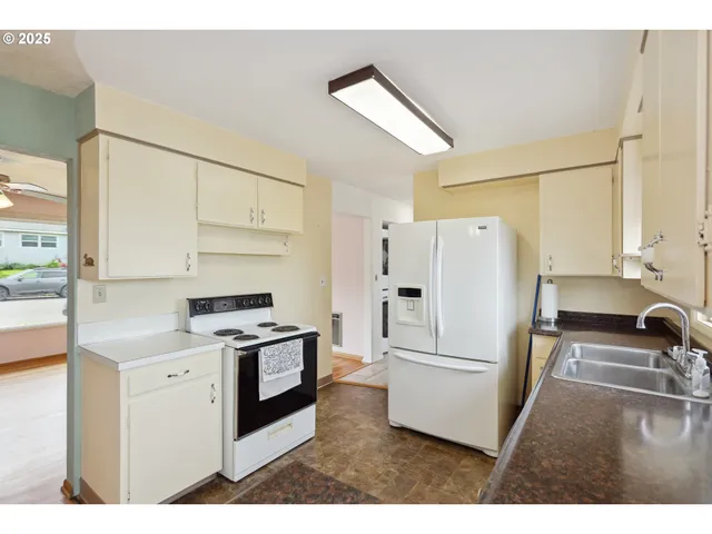 a kitchen with a refrigerator stove and sink