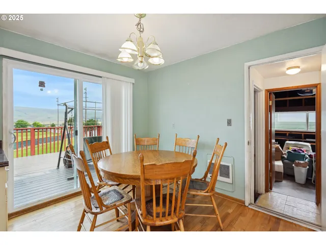 a view of a dining room with furniture wooden floor and chandelier