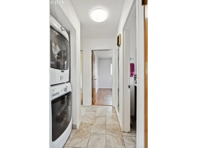 a view of a hallway with washer and dryer