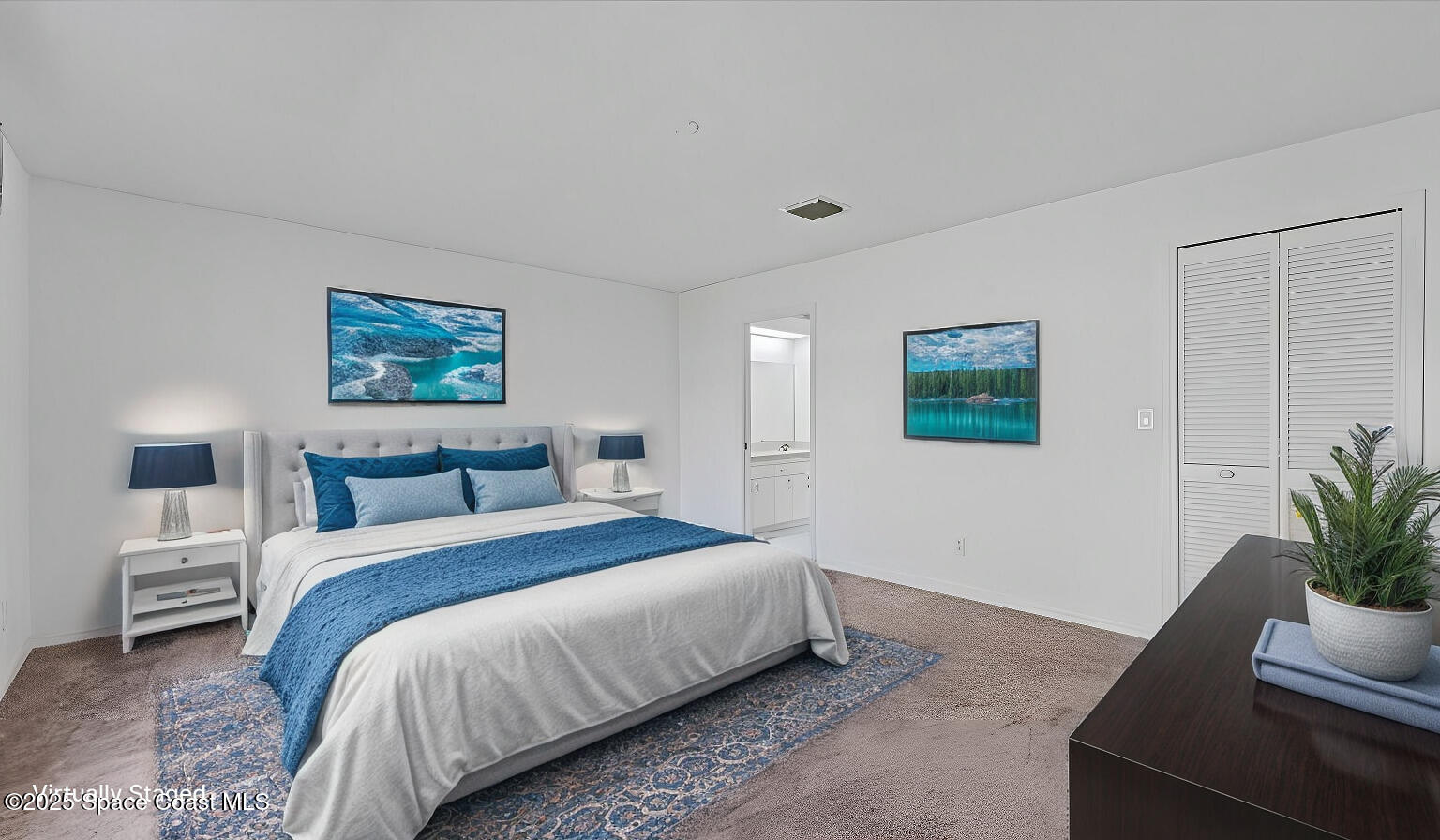 212 Crystal Lake Road Melbourne, FL 32901 - Photo 22 of 38 a bedroom with a large bed and a potted plant
