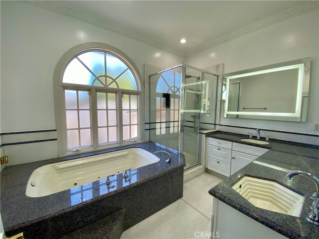11019 Rives Avenue Downey, CA 90241 - Photo 13 of 35 a bathroom with a tub sink and mirror