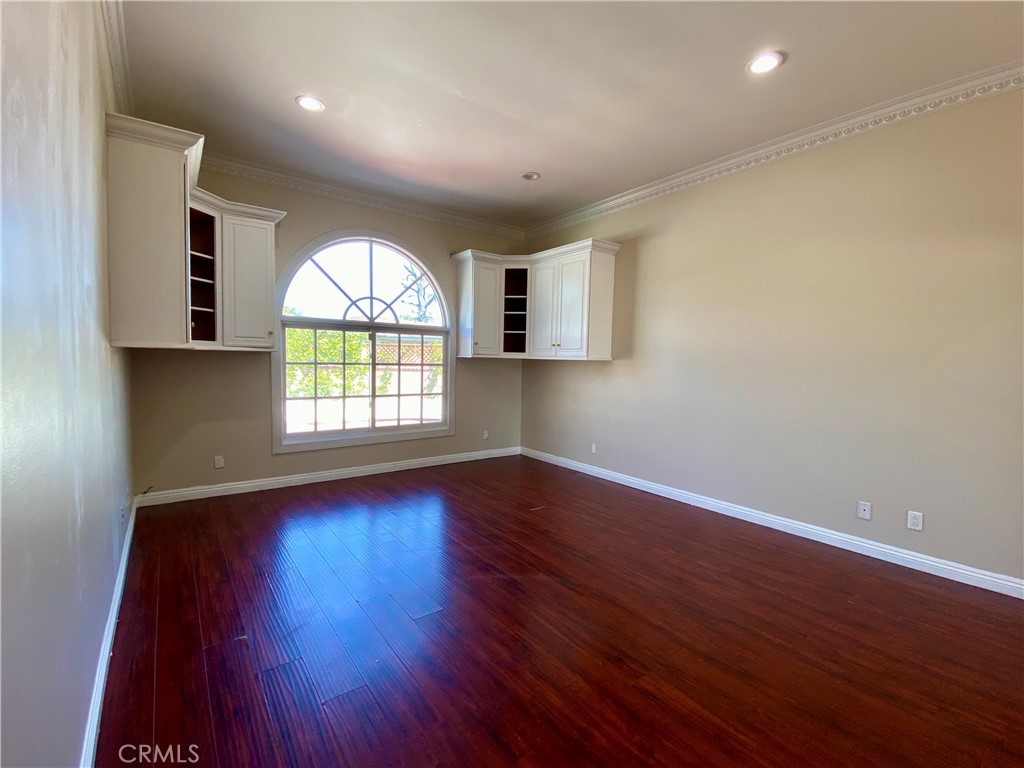 11019 Rives Avenue Downey, CA 90241 - Photo 20 of 35 an empty room with wooden floor and windows