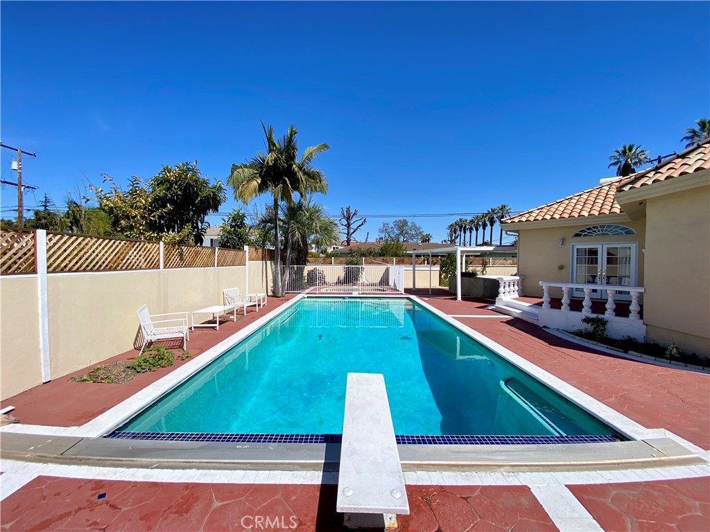 11019 Rives Avenue Downey, CA 90241 - Photo 32 of 35 a small pool with lawn chairs under an umbrella