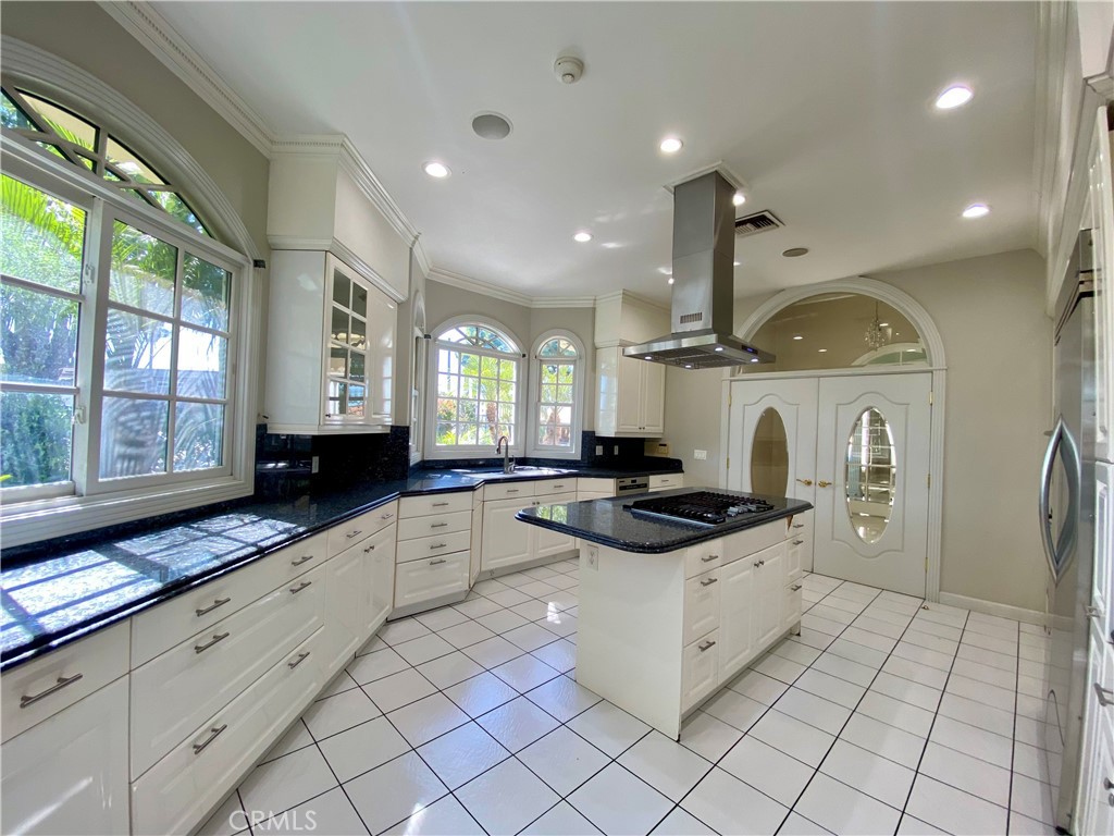 11019 Rives Avenue Downey, CA 90241 - Photo 5 of 35 a kitchen with stainless steel appliances granite countertop a sink and a stove
