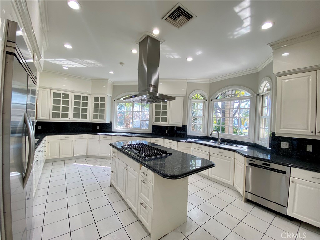 11019 Rives Avenue Downey, CA 90241 - Photo 7 of 35 a kitchen with stainless steel appliances granite countertop a stove a sink and a microwave