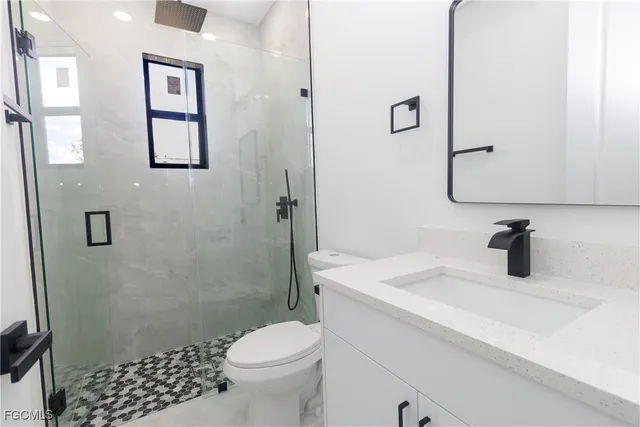 an empty room with a window and a ceiling fan