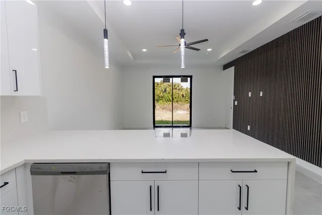 a kitchen with a sink and chandelier