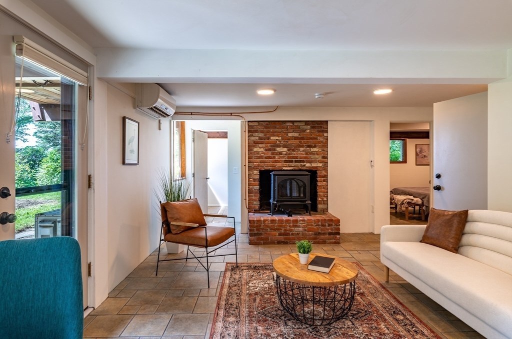 15 Cole Road Williamsburg, MA 01039 - Photo 20 of 35 a living room with furniture and a fireplace
