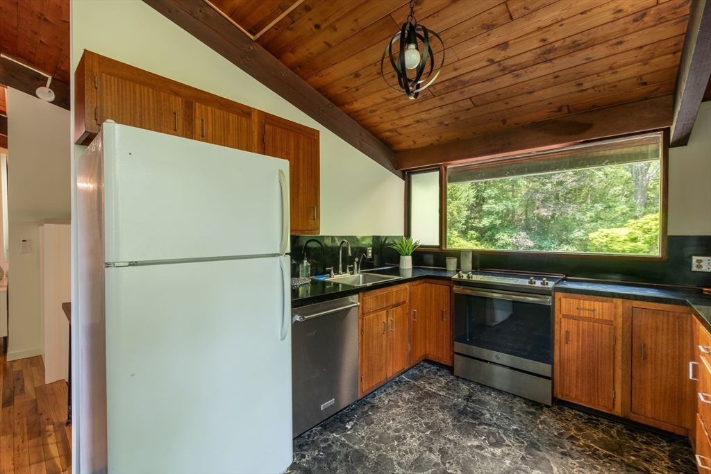 15 Cole Road Williamsburg, MA 01039 - Photo 10 of 35 a kitchen with stainless steel appliances granite countertop a refrigerator a sink a stove and a microwave oven