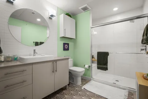 a bathroom with a toilet sink and mirror
