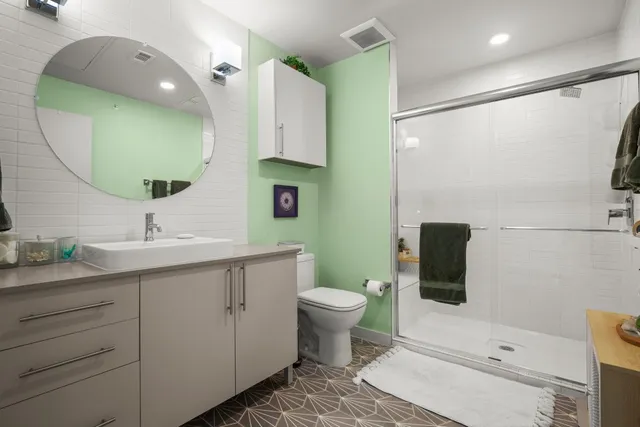 a bathroom with a toilet sink and mirror