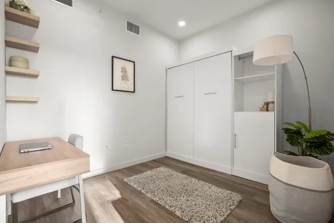 a view of workspace with furniture and wooden floor