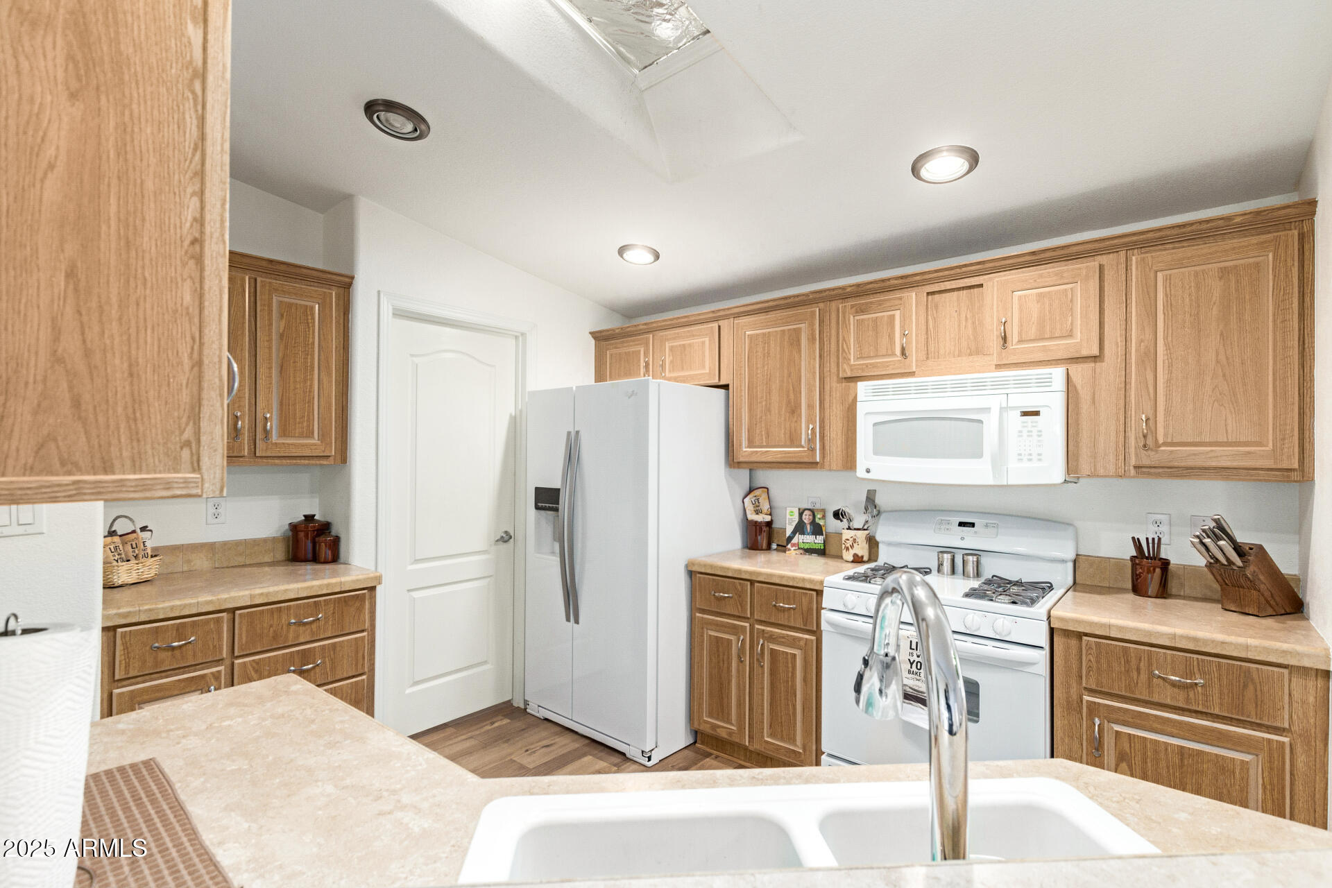 2929 East Main Street, Unit 83 Mesa, AZ 85213 - Photo 12 of 34 a kitchen with granite countertop a refrigerator a sink a stove and cabinets