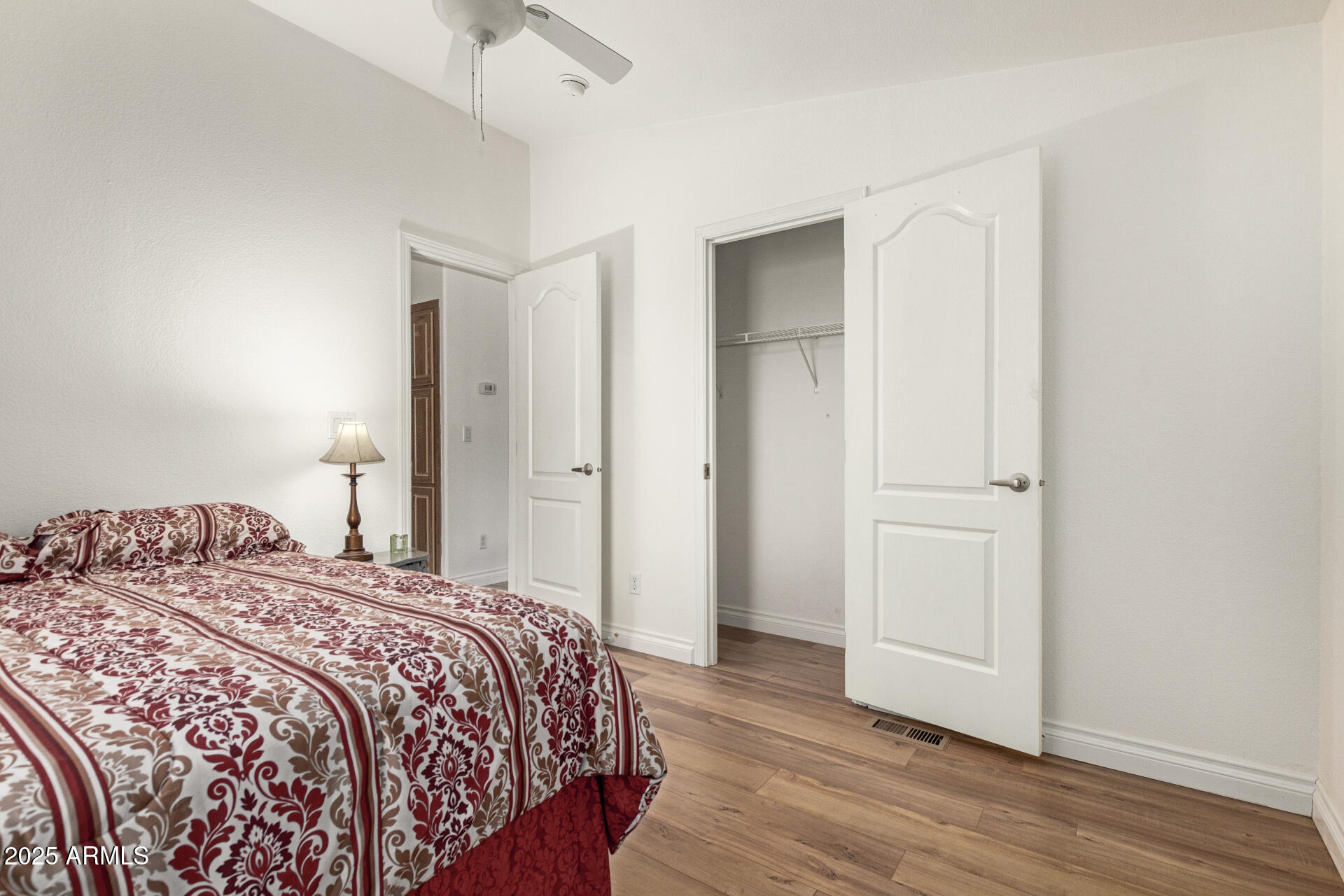2929 East Main Street, Unit 83 Mesa, AZ 85213 - Photo 20 of 34 a bedroom with a bed and a ceiling fan