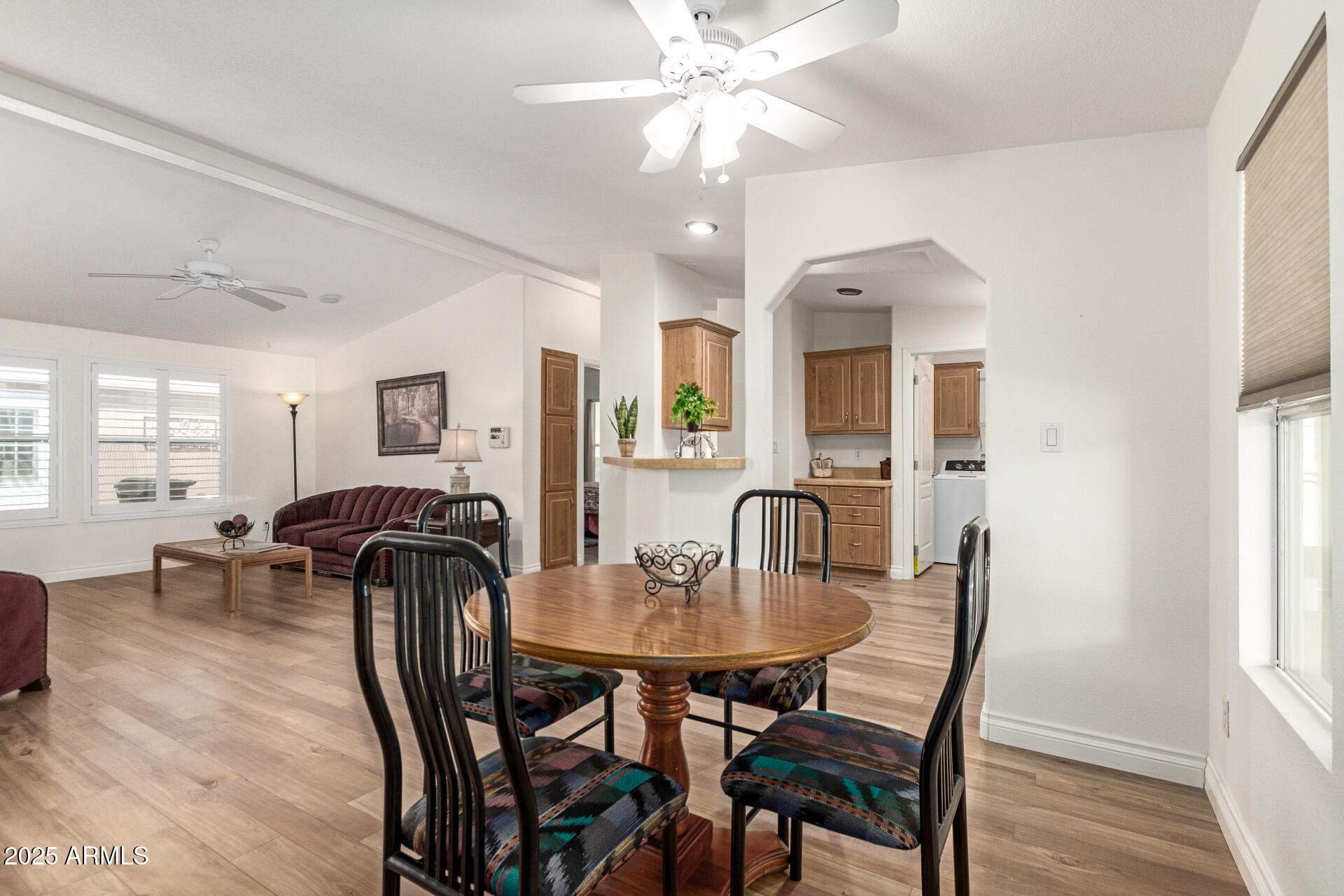2929 East Main Street, Unit 83 Mesa, AZ 85213 - Photo 9 of 34 a view of a a dining room with furniture window and wooden floor