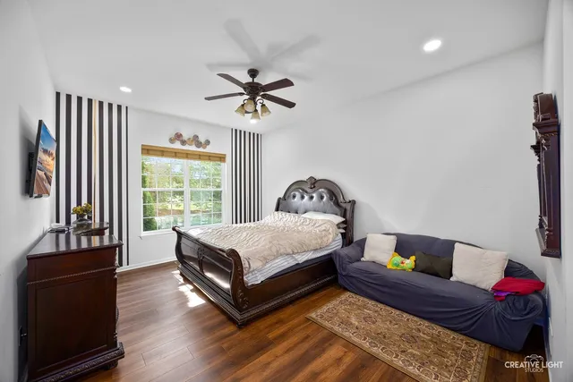 a spacious bedroom with a bed and a couch