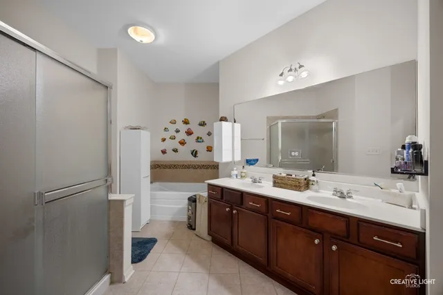 a spacious bathroom with a double vanity sink mirror and double