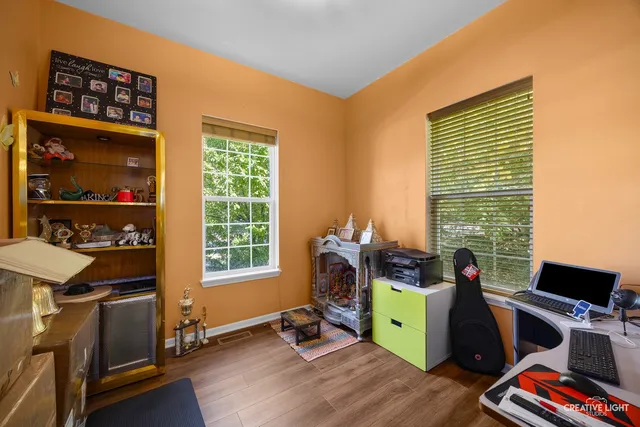 a view of a workspace with furniture and a window