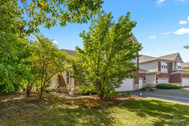 a view of a big house with a tree and a yard