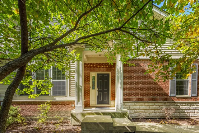 front view of a house with a tree
