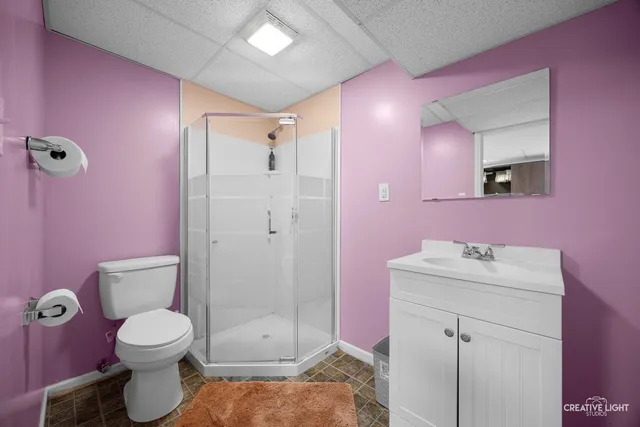 a bathroom with a sink toilet vanity and shower