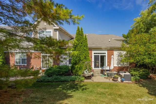 a view of a house with backyard porch and sitting area
