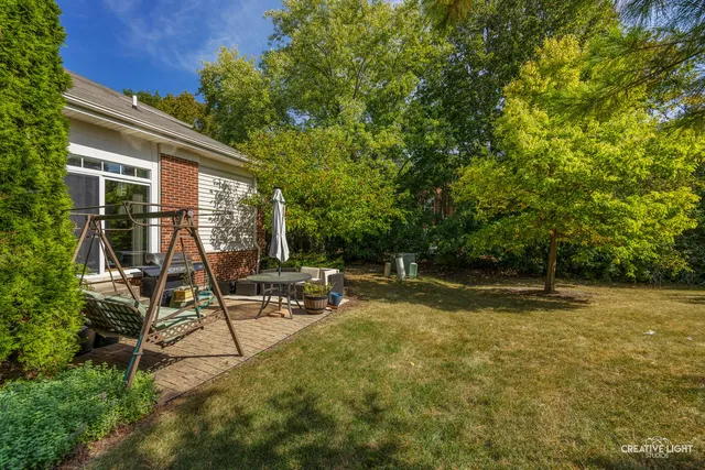 a view of a house with backyard and sitting area