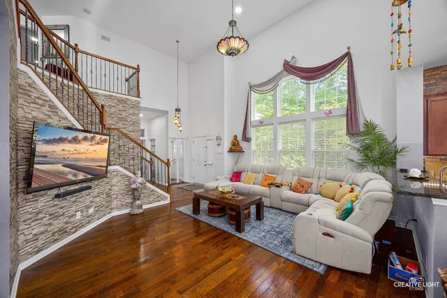 a living room with furniture fireplace and a large window