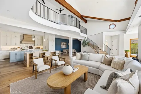 a living room with furniture wooden floor and a flat screen tv