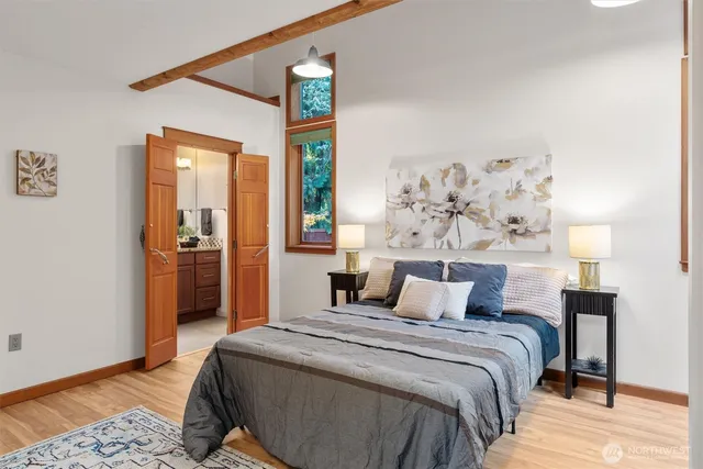 a bedroom with a large bed and a chandelier