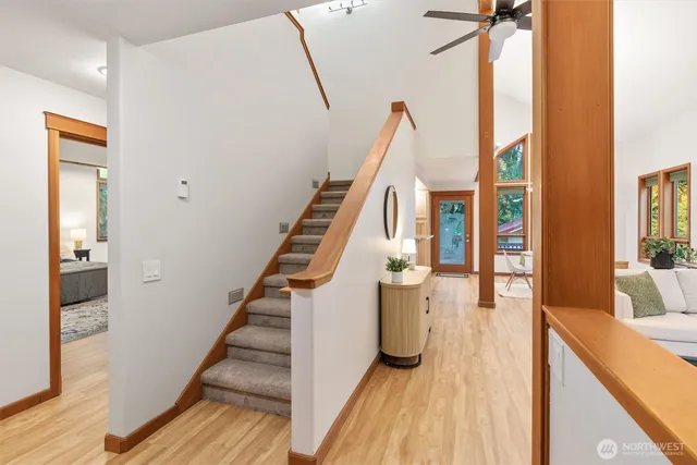 a view of a hallway with wooden floor and staircase