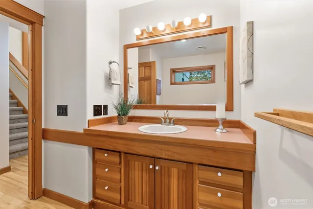 a bathroom with a sink vanity and a mirror