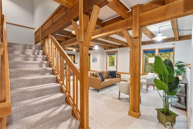 a view of staircase with white walls and a potted plant