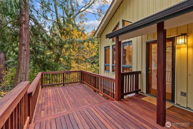 a view of balcony with wooden floor and fence