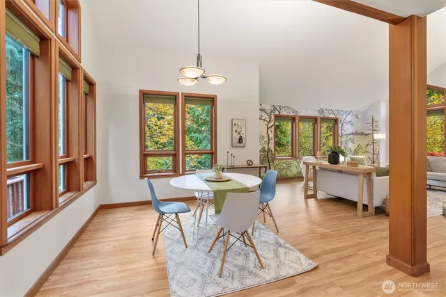 a view of a dining room with furniture window and wooden floor