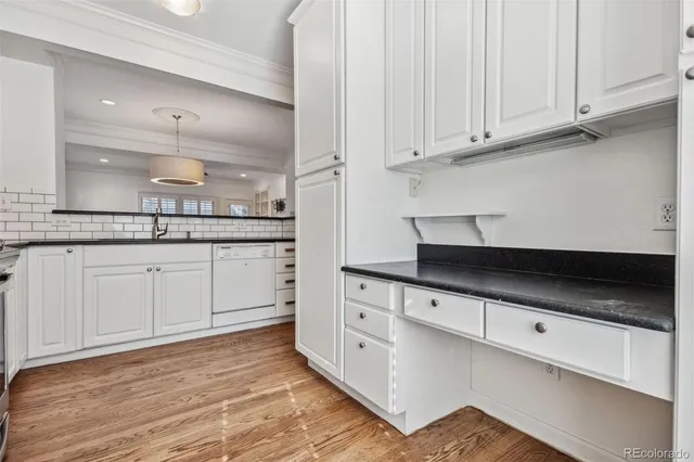 a view of a hallway with wooden floor and entryway