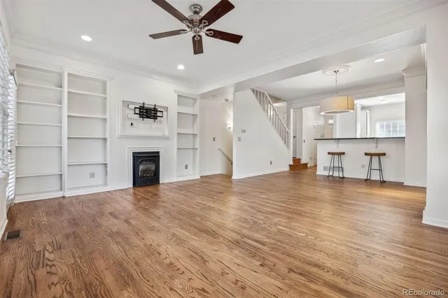 a view of empty room with wooden floor and window