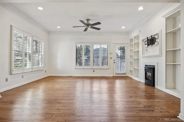 a view of a kitchen with wooden floor and chairs