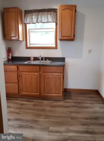 a view of kitchen with wooden floor and window