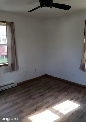 a view of wooden floor and windows in an empty room