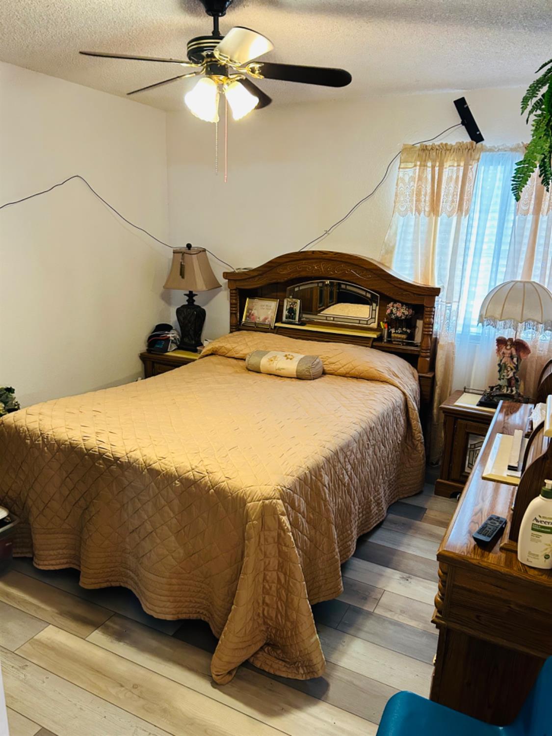 355 J Street Mendota, CA 93640 - Photo 15 of 21 a bedroom with a bed and a chandelier