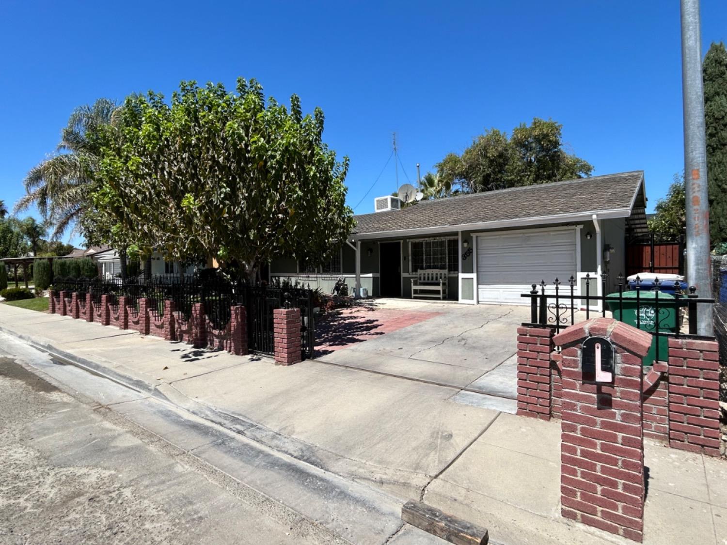 355 J Street Mendota, CA 93640 - Photo 2 of 21 a view of a patio with table and chairs with wooden fence and plants