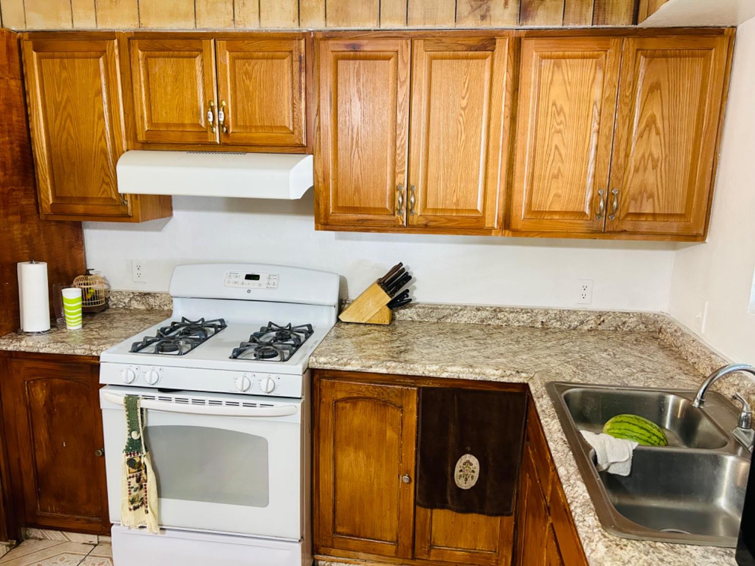 355 J Street Mendota, CA 93640 - Photo 9 of 21 a kitchen with granite countertop a sink a stove and cabinets