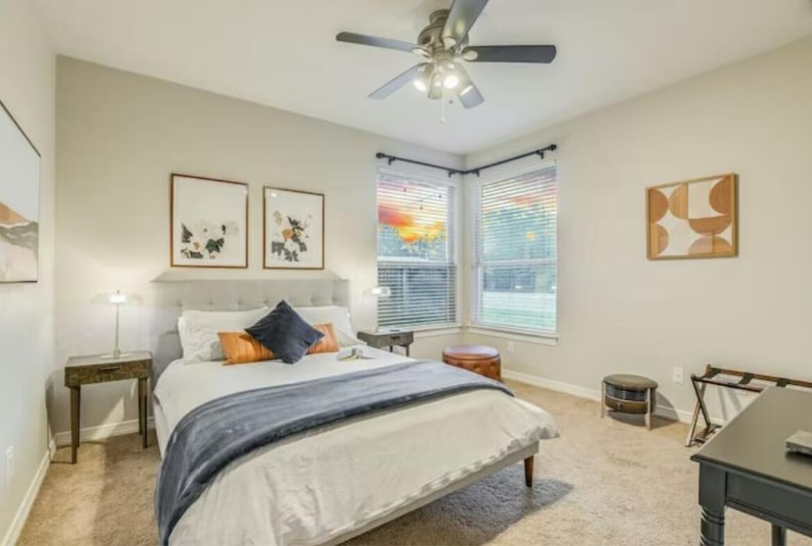 413 Breakaway Road Cedar Park, TX 78613 - Photo 12 of 21 Bedroom with light colored carpet and a ceiling fan
