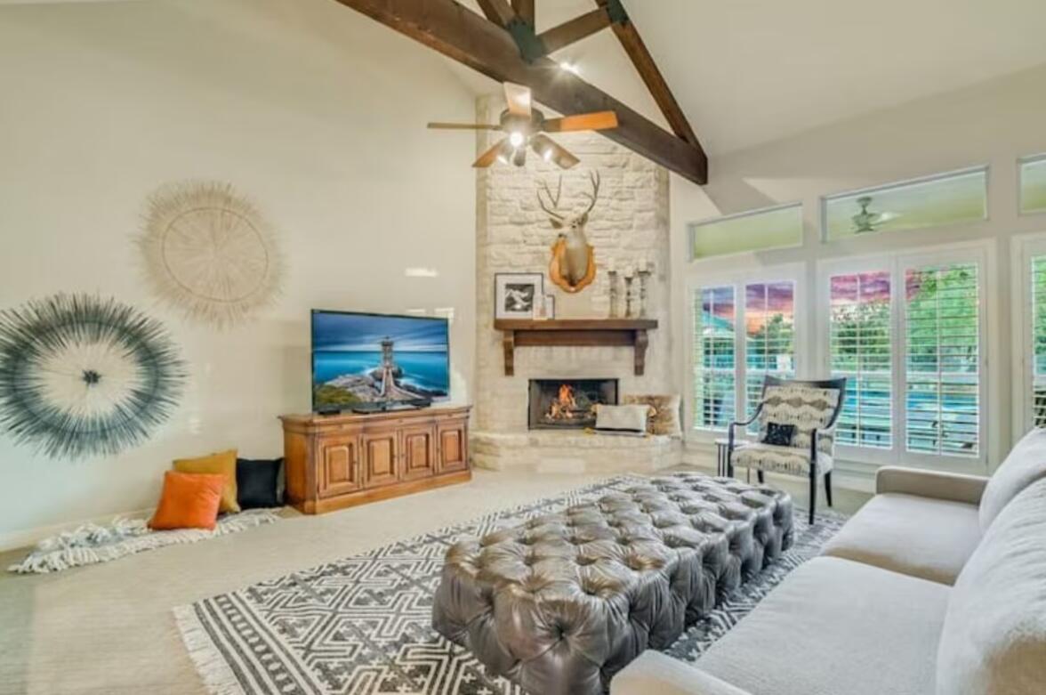 413 Breakaway Road Cedar Park, TX 78613 - Photo 16 of 21 Living room featuring a ceiling fan, lofted ceiling, a fireplace, and carpet flooring