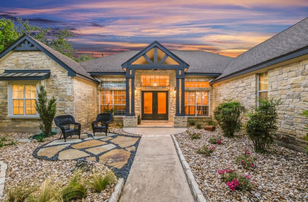 413 Breakaway Road Cedar Park, TX 78613 - Photo 17 of 21 Exterior entry at dusk with french doors and stone siding